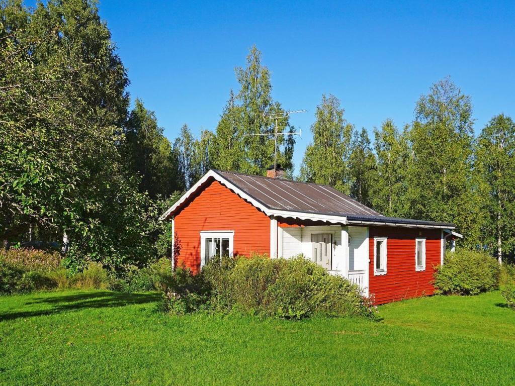 a red and white house in the middle of a field at 6 person holiday home in TORSBY in Överbyn