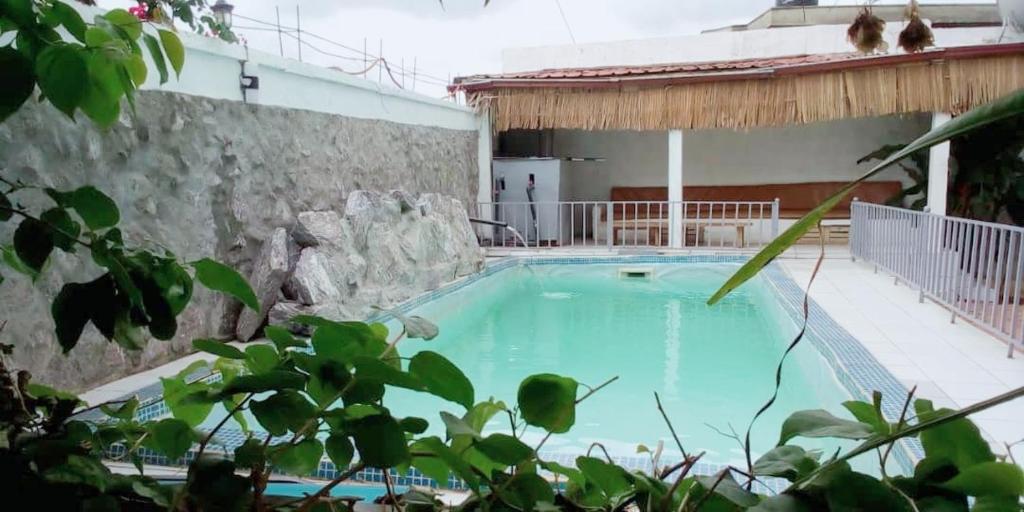 a large swimming pool next to a building at Appartement haut standing avec piscine in Yaoundé