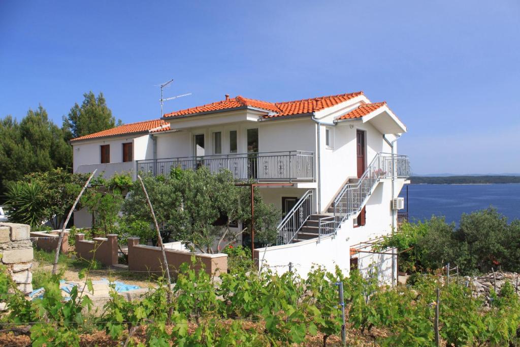 a house with a view of the water at Apartments with a parking space Zavala, Hvar - 8773 in Zavala