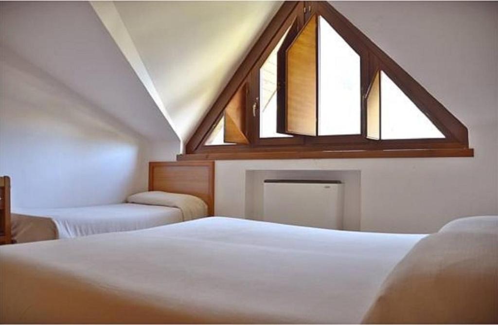 Postel nebo postele na pokoji v ubytování Hotel Margherita
