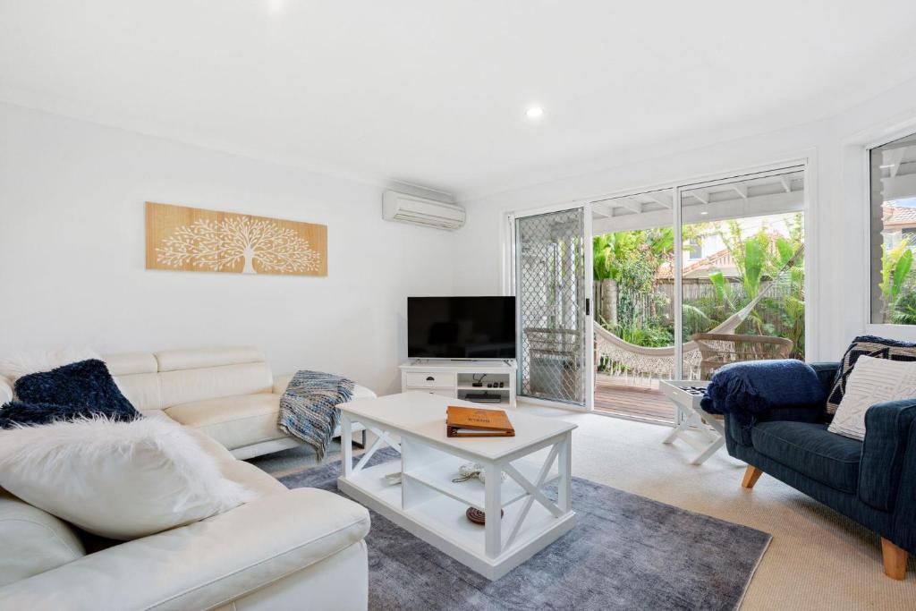 a living room with a couch and a table at Eastpoint 3 in Byron Bay