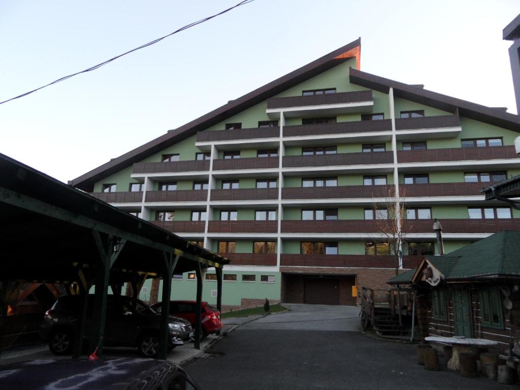 a large building with a parking lot in front of it at Apartmenty PATRIS in Tatranska Strba