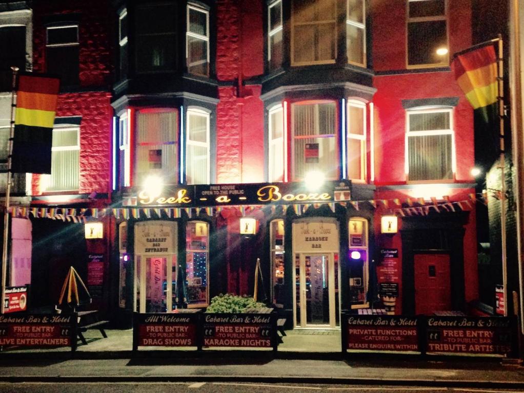 a store front of a building at night at Peek-a-Booze - Budget Hotel - Adults Only in Blackpool