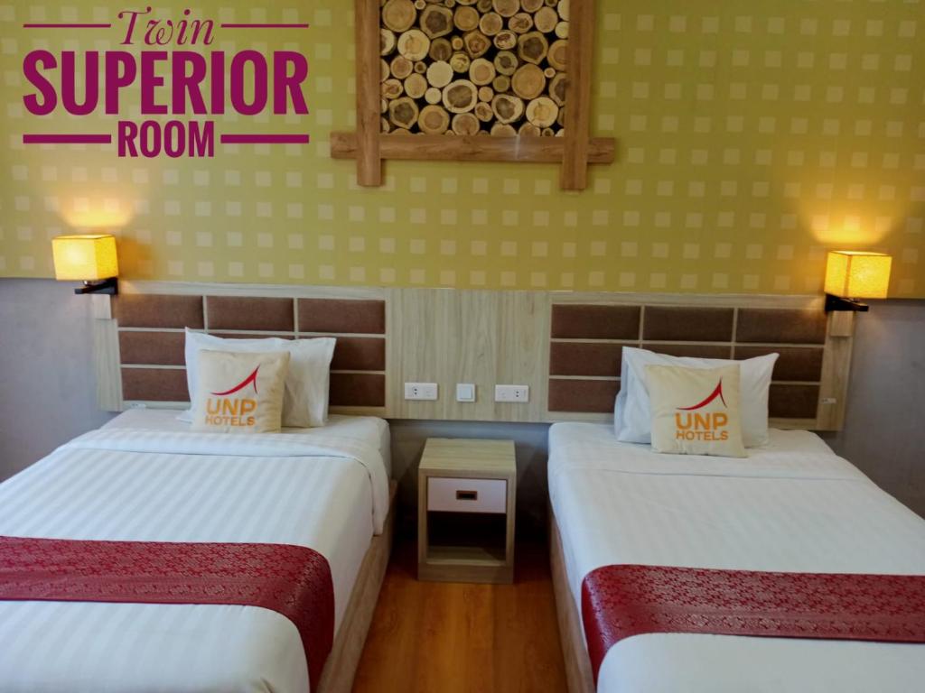 Postel nebo postele na pokoji v ubytování UNP Hotel & Convention