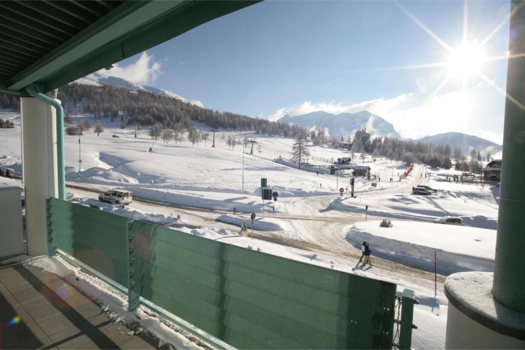 a view of a snow covered ski slope from a balcony at Teleo 50mt From Ski Apartments - Happy Rentals in Sestriere