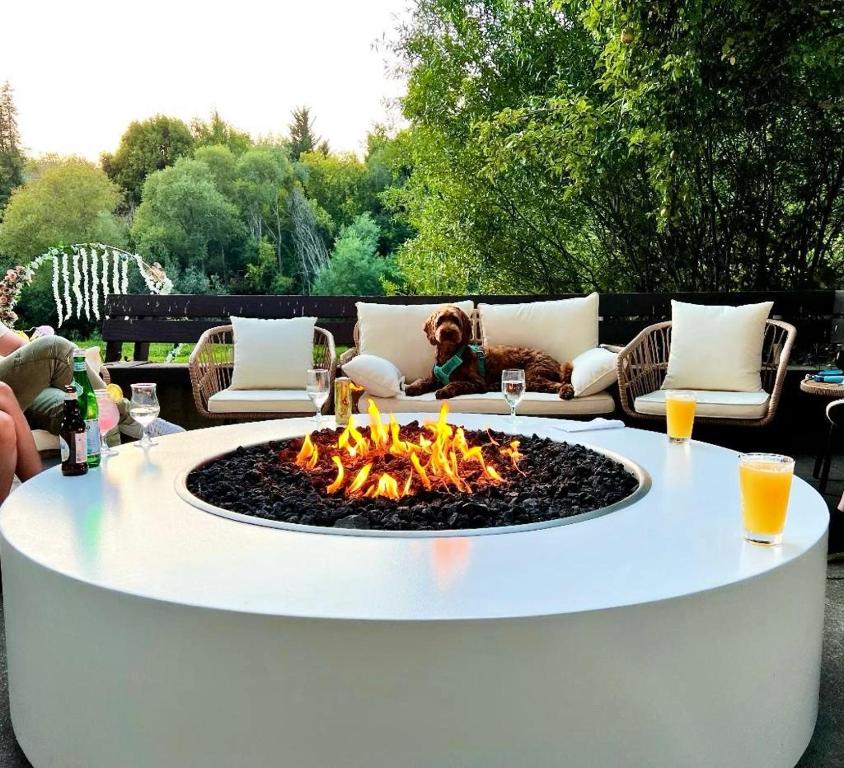 a little girl sitting on a couch around a fire pit at Boho Manor in Monte Rio