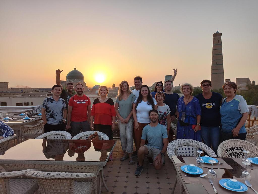 a group of people posing for a picture on a roof at Minor Boutique Hotel in Khiva
