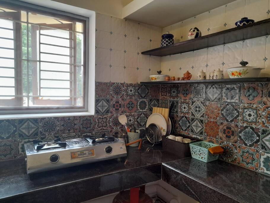 a kitchen with a sink and a stove in it at SHI's Shambhavi homestay -On the way to Isha, Maruthamalai in Coimbatore