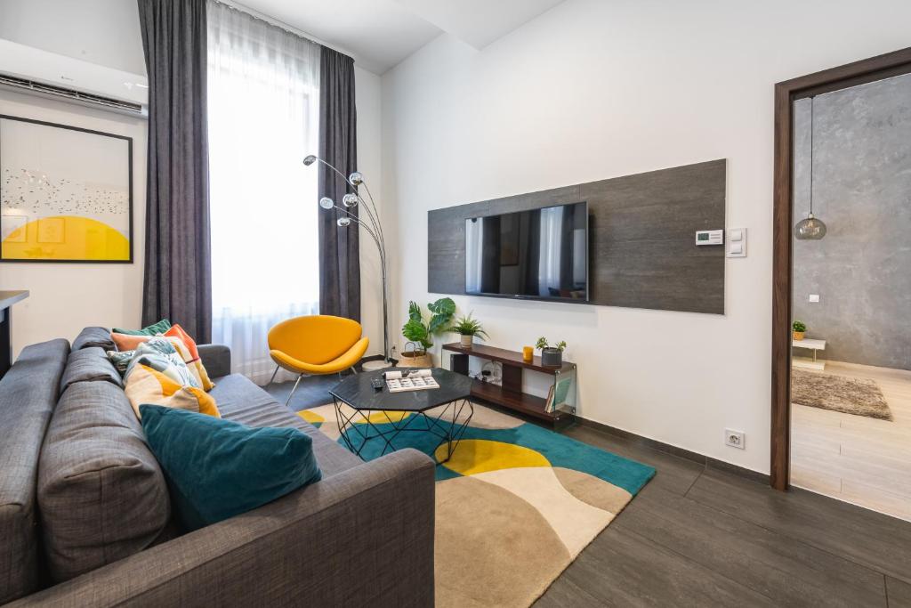 a living room with a couch and a tv at Luxury Nova Home next to the New York Café in Budapest