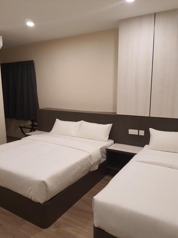 Postel nebo postele na pokoji v ubytování T SQUARE HOTEL (IPOH)