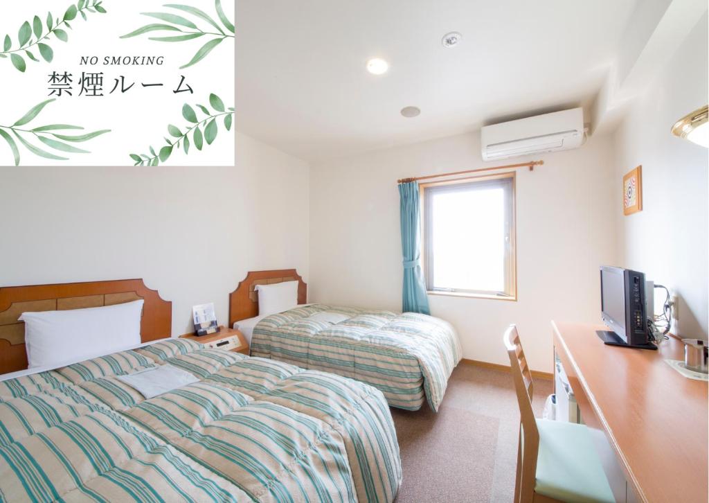 Postel nebo postele na pokoji v ubytování Hyper Hotel Komatsu