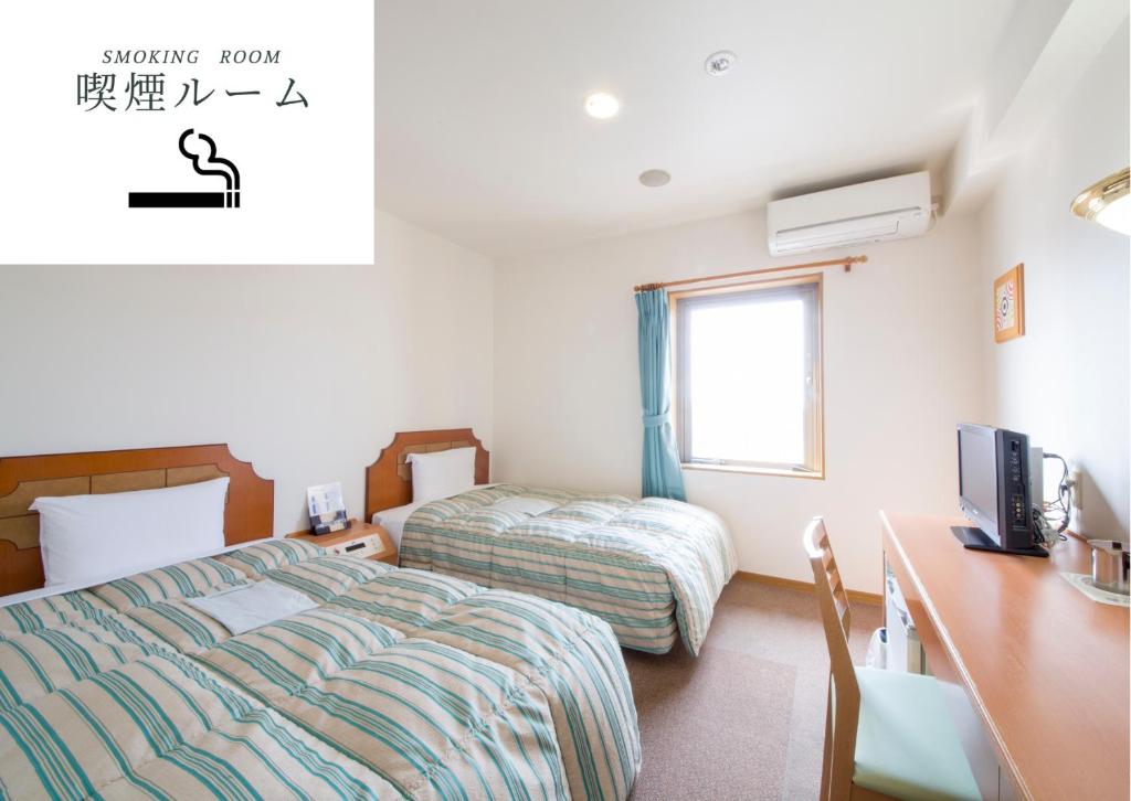 Postel nebo postele na pokoji v ubytování Hyper Hotel Komatsu