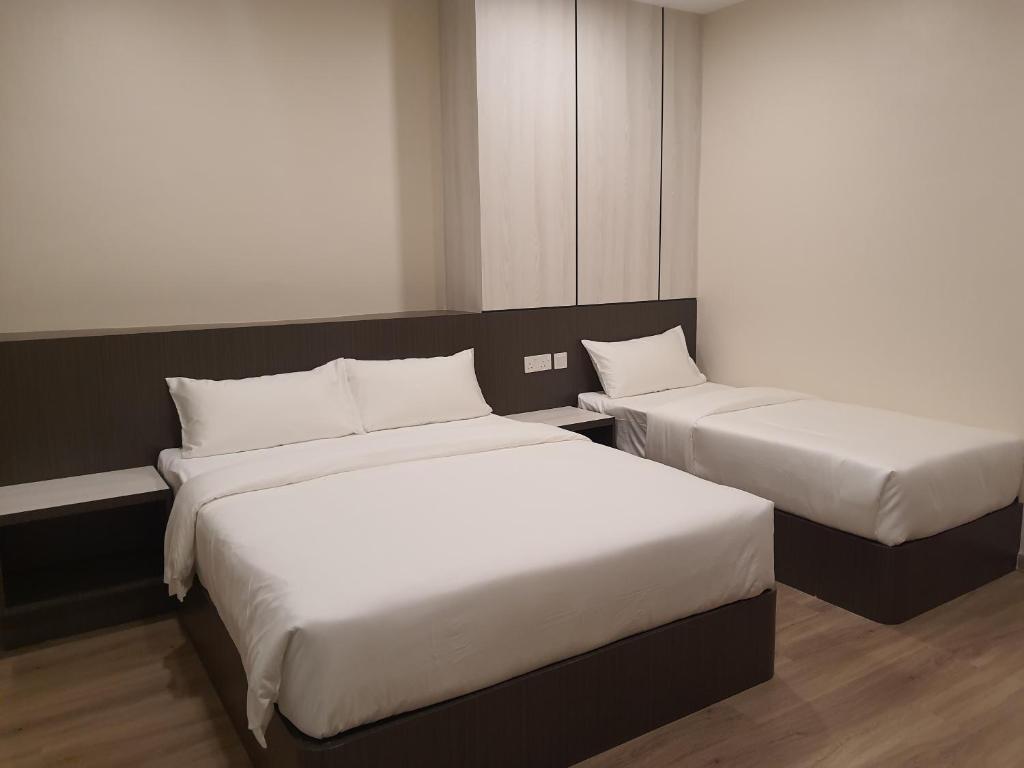 Postel nebo postele na pokoji v ubytování T SQUARE HOTEL (IPOH)