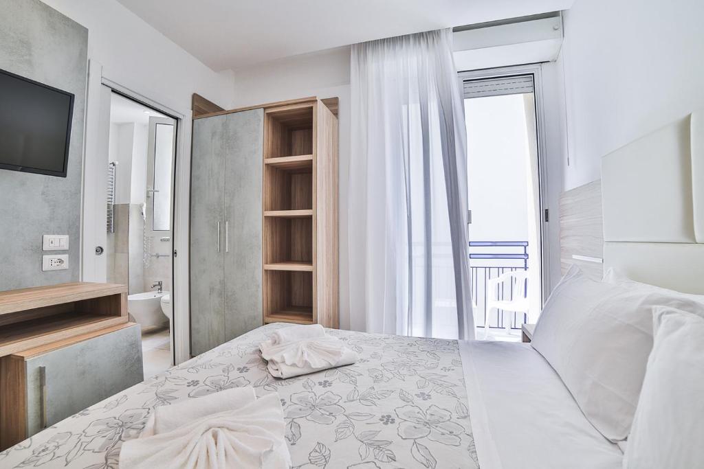 Postel nebo postele na pokoji v ubytování Hotel Ambasciatori