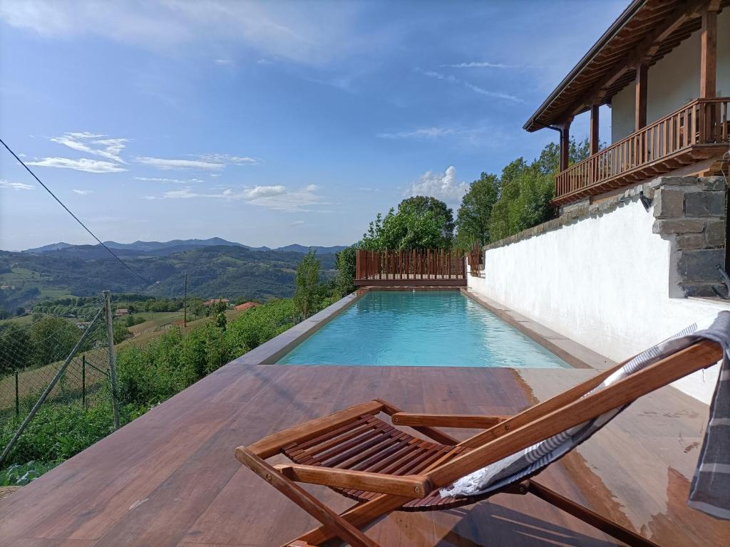 a deck with a chair and a swimming pool at Apartamento Atari in San Martín