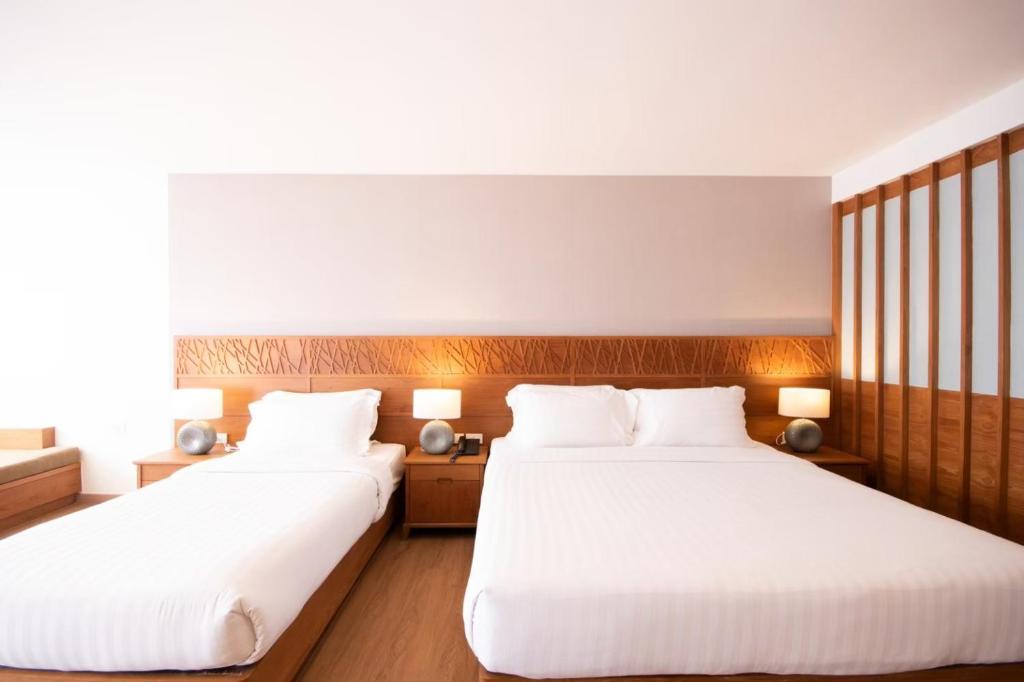 Postel nebo postele na pokoji v ubytování Areca Lodge
