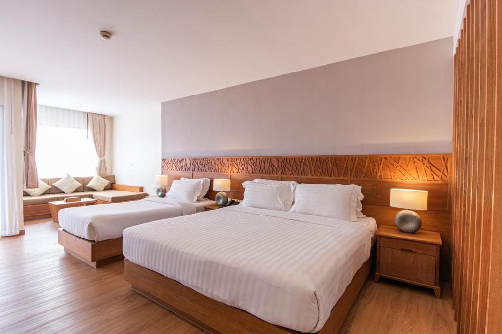 Postel nebo postele na pokoji v ubytování Areca Lodge