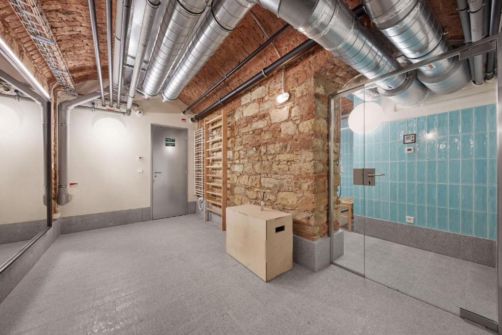 an empty room with a brick wall and a table at Luxury apartment in the centre in Prague