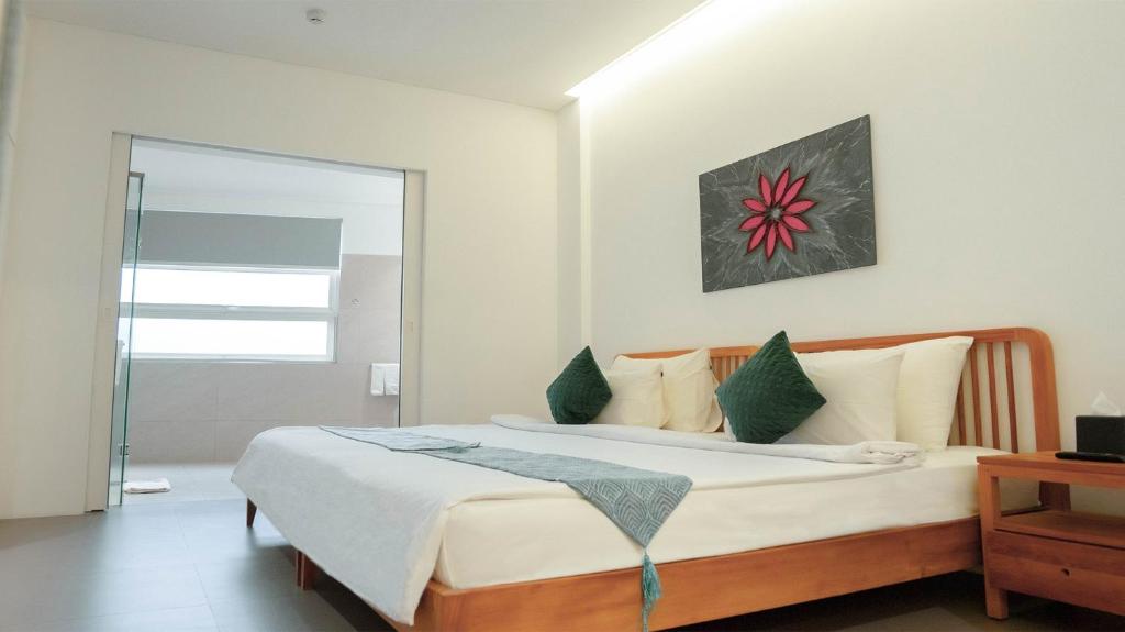 Postel nebo postele na pokoji v ubytování K Gallery Hotel