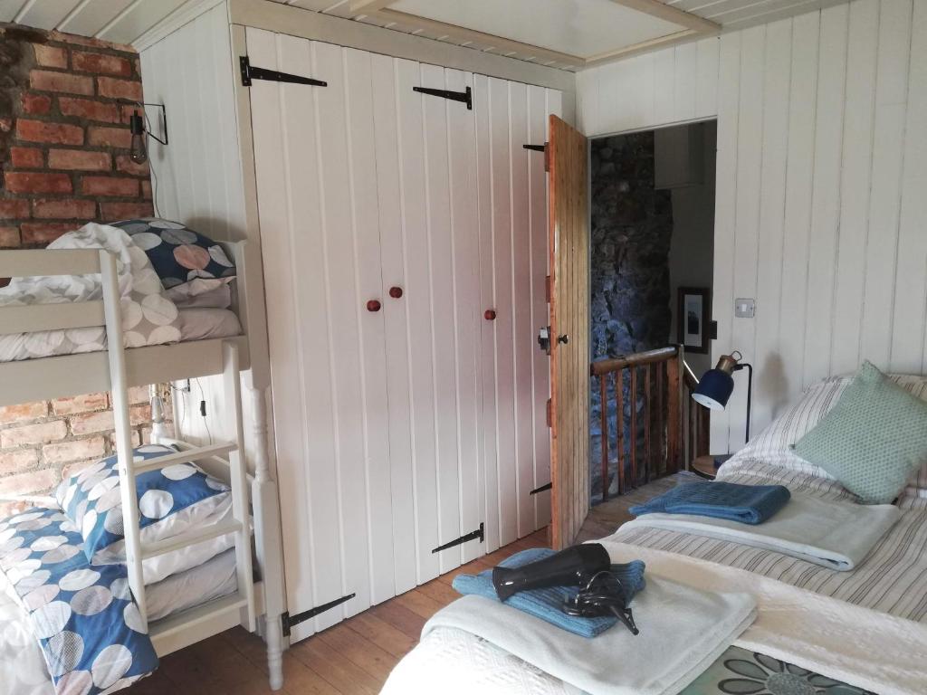 a room with a bunk bed and two bunk beds at Shoe Trader's Terrace in Rathmullan