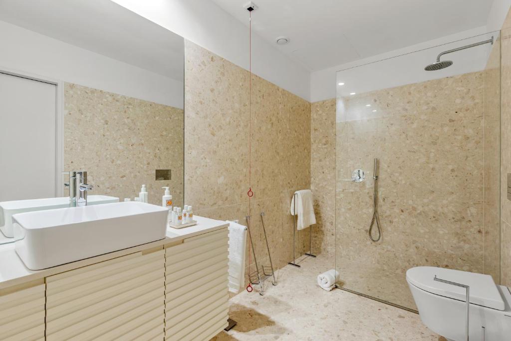 a bathroom with a toilet and a sink and a shower at 108MM House in Porto