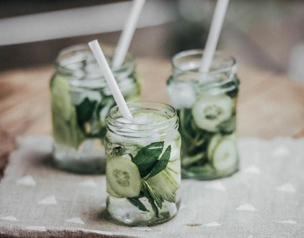 three mason jars with pickles on a table at The Bay Hotel & Suites in Vasilikos