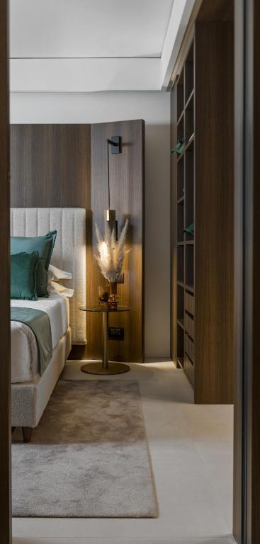 a bedroom with a bed and a table at We Me Suite Hotel in Riccione