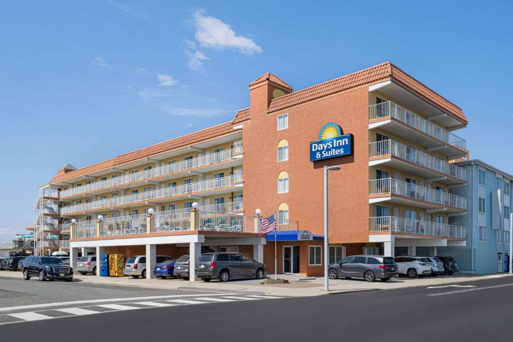 a hotel with a parking lot in front of it at Days Inn & Suites by Wyndham Wildwood in Wildwood