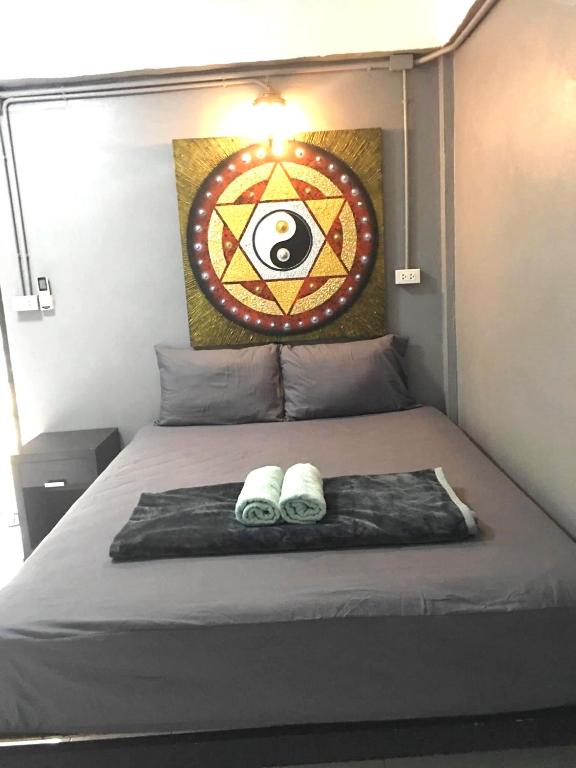 a bedroom with a bed with two slippers on it at Hotel4U Koh Tao in Ko Tao