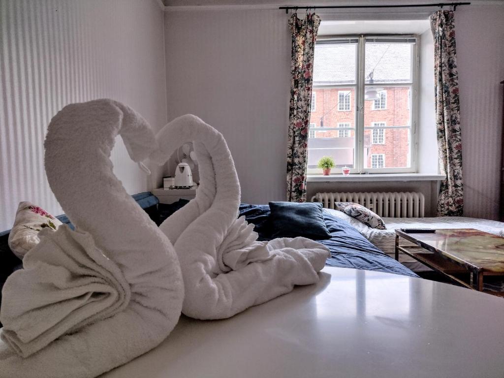 a towel animal laying on the floor of a bedroom at Quiet Central Room in Stockholm