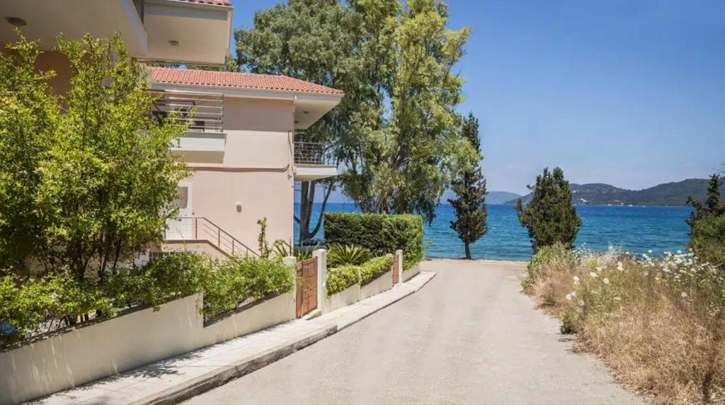 dom na polnej drodze obok wody w obiekcie Eucalyptus Apartments Apartment Meli w mieście Karavomylos