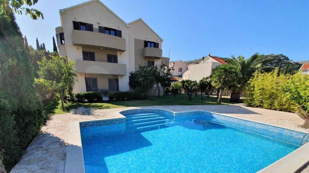 an image of a swimming pool in front of a building at Palm Apartments with Swimming pool in Mlini