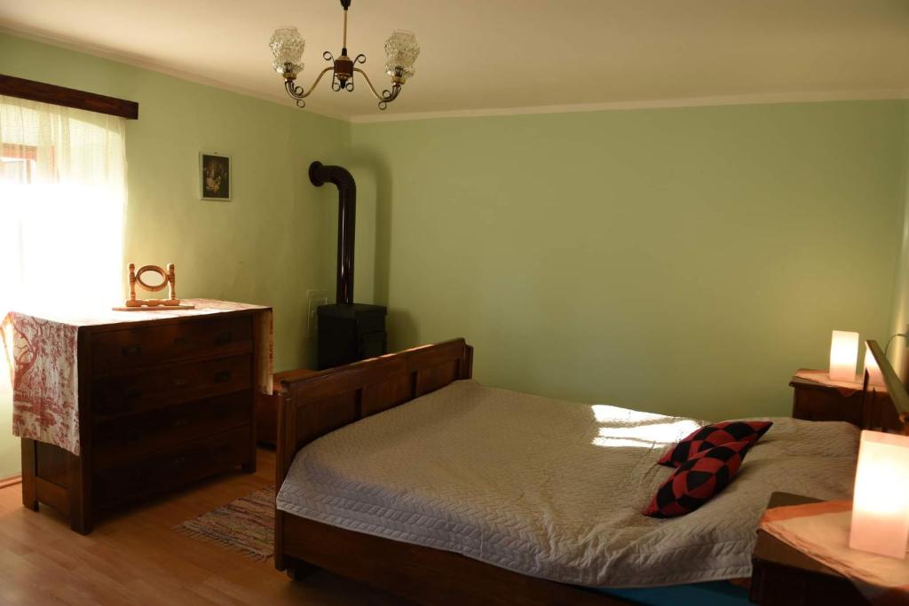 a bedroom with a bed and a dresser at Kuća za odmor Beljan in Brod na Kupi