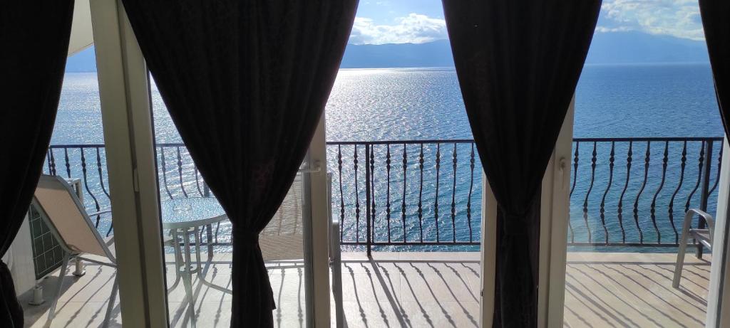 a view of the ocean from the balcony of a house at Villa Eros Apartments 2 in Struga