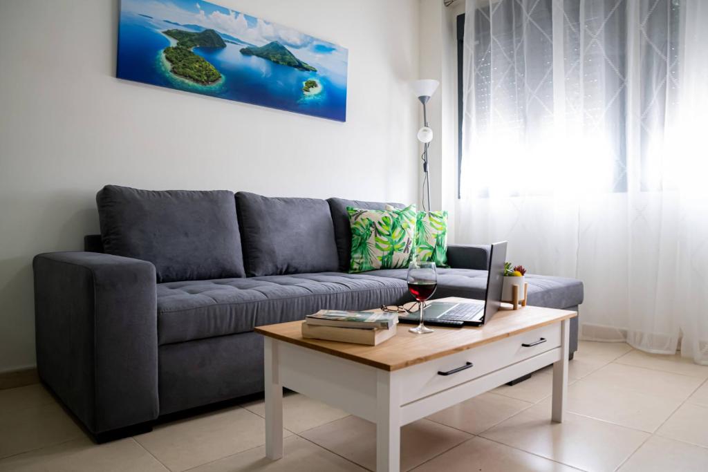 a living room with a couch and a coffee table at Apartamento Timple in Icod de los Vinos