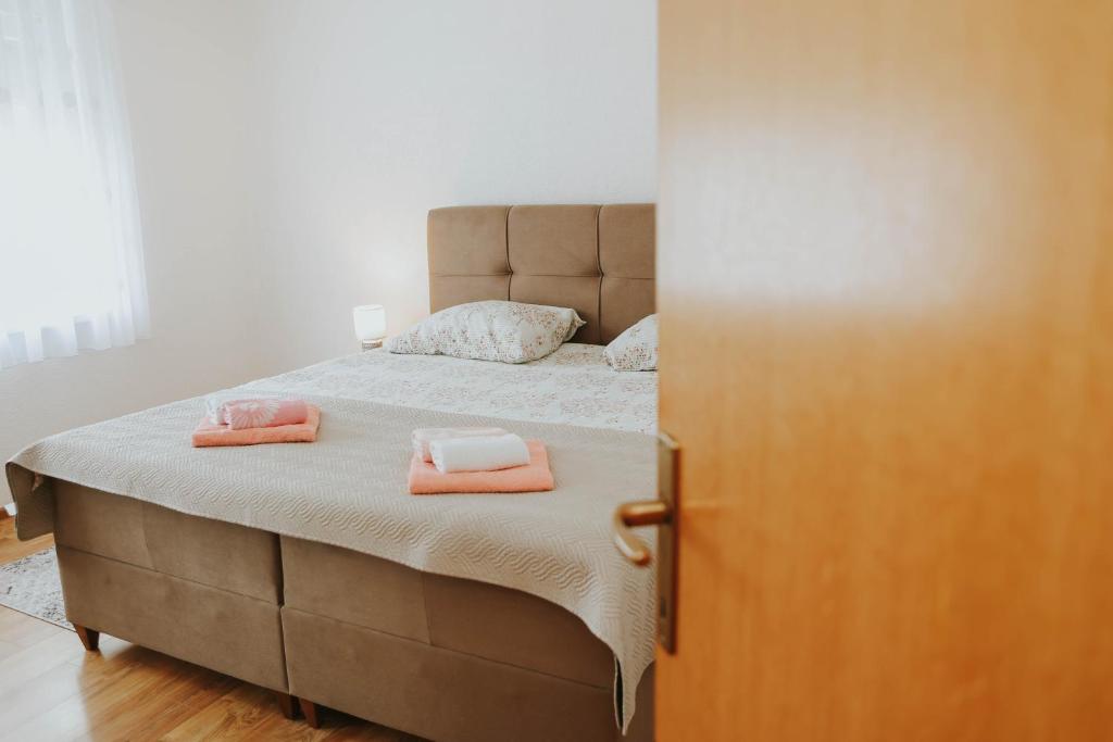 a bedroom with a bed with two towels on it at I&T apartman in Gospić