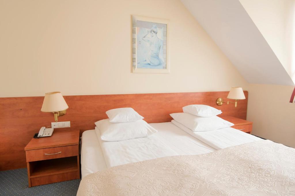 Postel nebo postele na pokoji v ubytování Hotel Daria