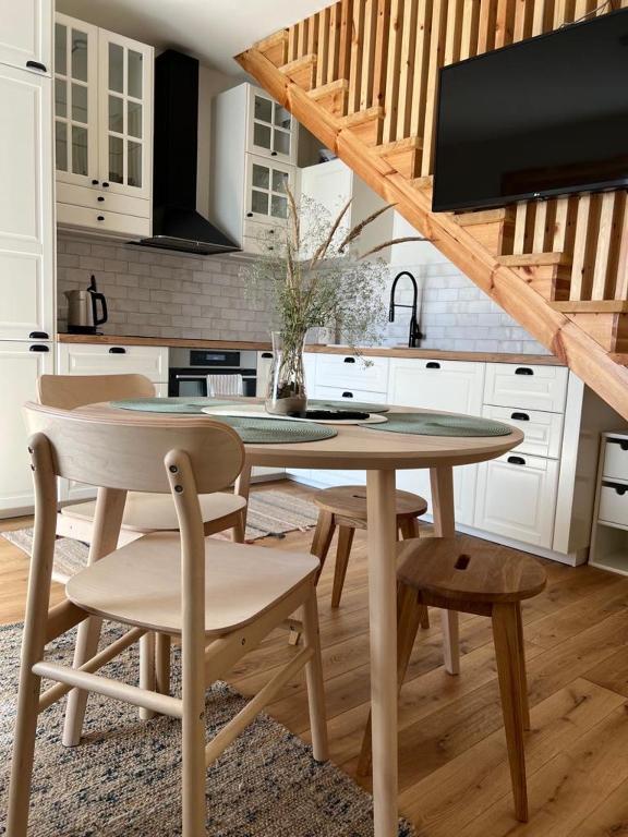 a kitchen with a table and chairs in a room at Rugio namai-Rye house in Palanga