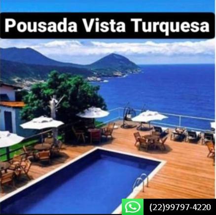 a sign for a resort with a swimming pool and the ocean at Pousada e Restaurante Vista Turquesa in Arraial do Cabo