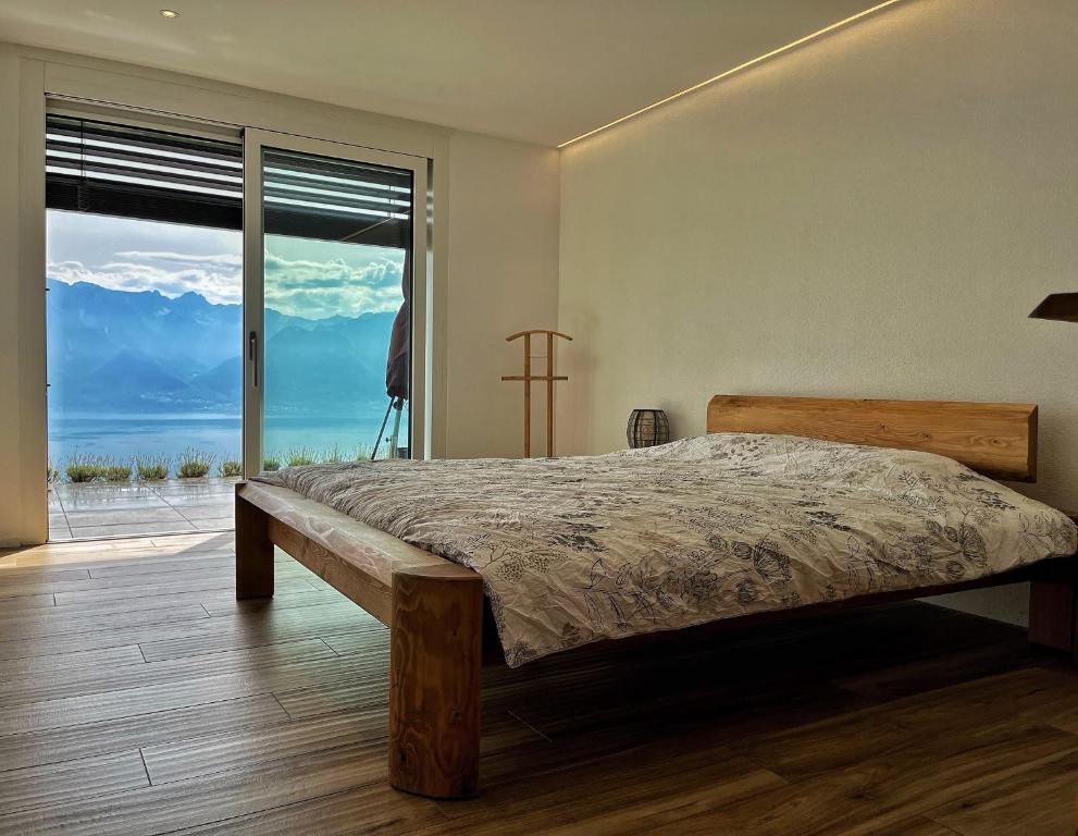 Ένα ή περισσότερα κρεβάτια σε δωμάτιο στο Appartement moderne avec vue panoramique à Jongny proche de Montreux