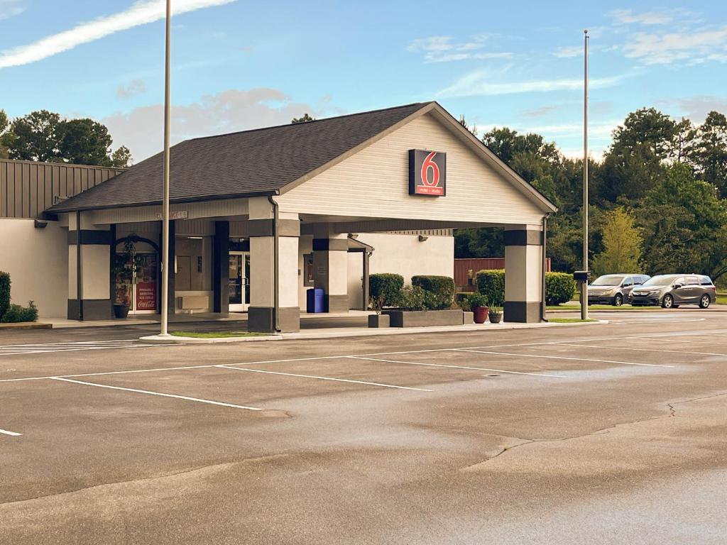 a parking lot in front of a gas station at Studio 6 Bay Minette AL in Bay Minette