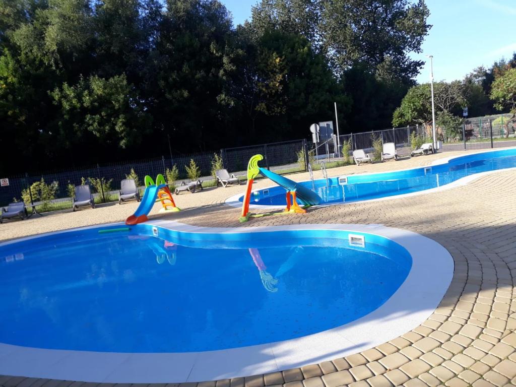 an empty swimming pool with a slide in a park at Pokój 31 Domino Family Dominikana in Sianozety