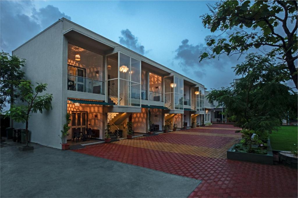 a building with a lot of windows on the side of it at Kalangan Farms By Spicy Mango in Alibaug