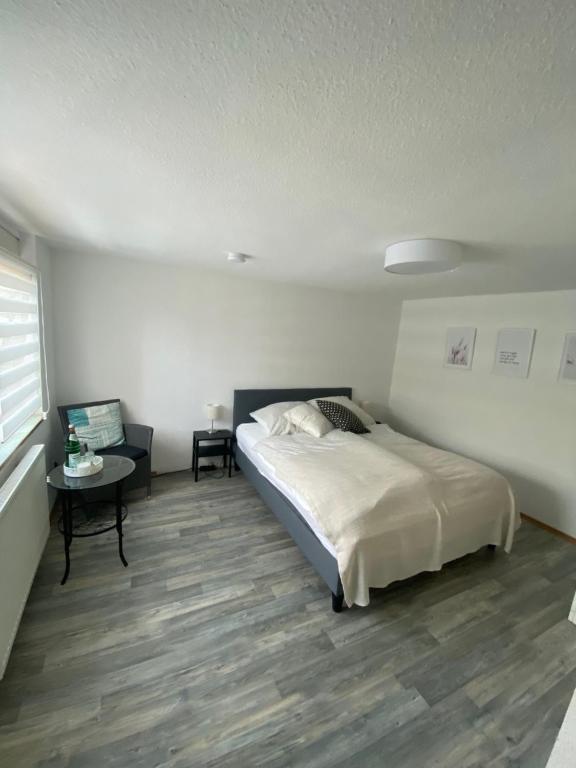 a bedroom with a bed and a table in it at Kleines Apartment in Siegburg-Kaldauen in Siegburg