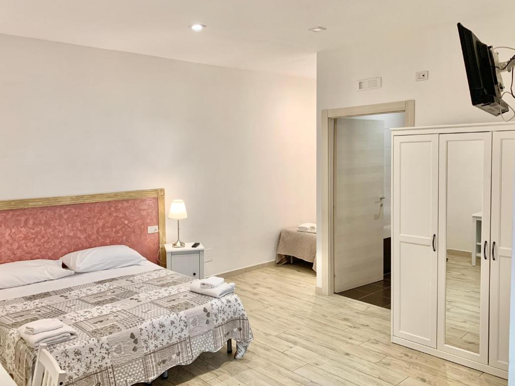 A bed or beds in a room at Romano B&B