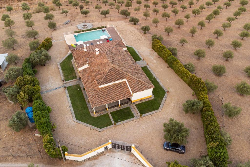 an overhead view of a large house with a pool at Monte Ribeira de Mures in Évora