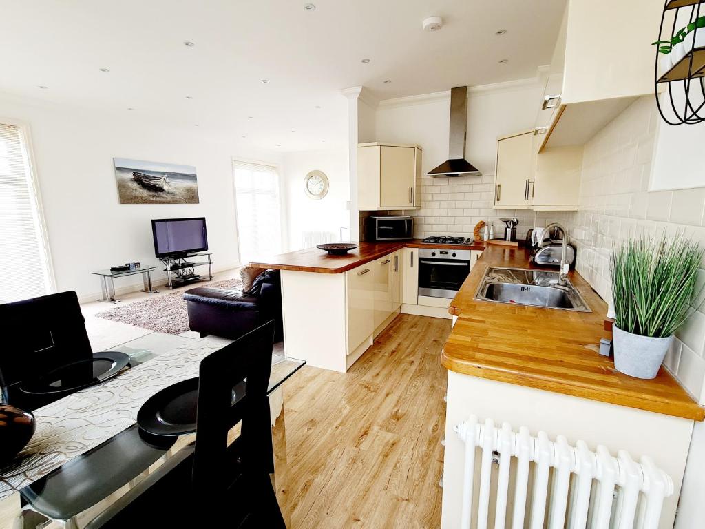 a kitchen with a sink and a counter top at Seas the Day Beachfront Apartment Ramsgate - Sleeps 4 in Ramsgate