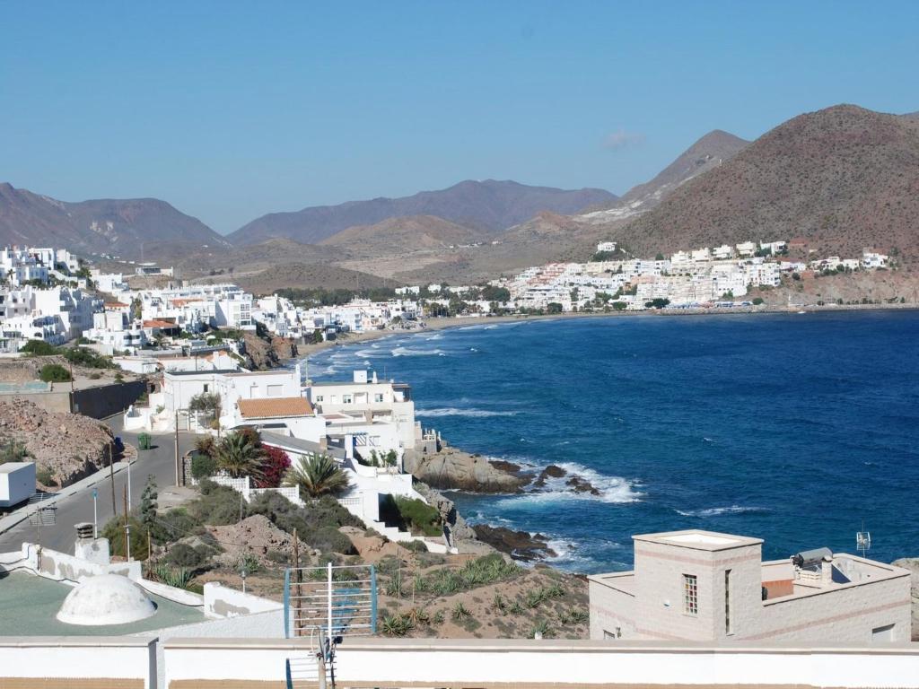a view of a town with the ocean and buildings at Apartamentos Dulcemar Frente al Mar con zona SPA in San José