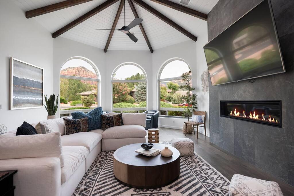 a living room with a couch and a fireplace at Amazing Luxury Home with Hot Tub & Views in Sedona