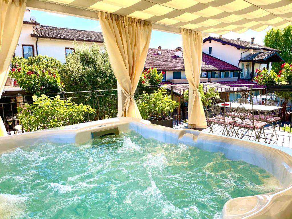 a jacuzzi tub on a patio with at Dimora di Charme Rooms & Apartments in Peschiera del Garda